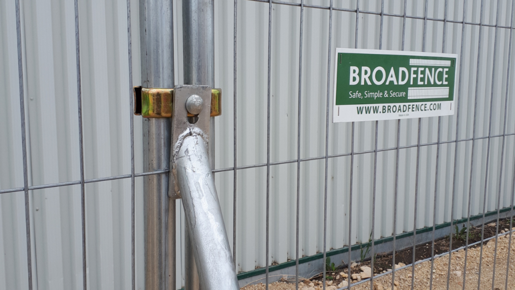 Broadfence lockable coupler securing temporary fence panels at an outdoor event for anti-tamper perimeter security
